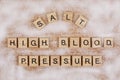 Wooden Letters spelling Salt High Blood Pressure on wooded background Royalty Free Stock Photo
