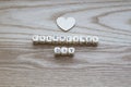 Wooden Letters spelling Valentines Day love hearton a Wooden background with one wooden heart placed above