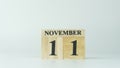 Wooden letters write the word November and the numbers 11 on white background with copy space. 11.11 single day sale Royalty Free Stock Photo