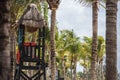 Wooden life guard hut on tropical beach with palm trees on a sunny day Royalty Free Stock Photo