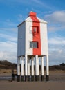 Wooden lighthouse on a beach