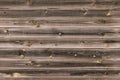 Wooden lining boards wall. midtone brown wood texture. background old panels, Seamless pattern. Horizontal planks