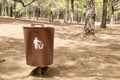 Wooden litter bin in the forest.