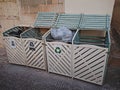 Wooden litter boxes near residential building on street