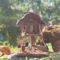 Wooden little house of a fabulous creature in the park in summer Royalty Free Stock Photo