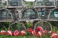 Old-fashioned lobster traps and buoys piled up on display outside a waterfront business. Royalty Free Stock Photo