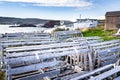 Wooden lobster traps overlooking fishing boats dragged-up on shore along the Canadian East coast. Royalty Free Stock Photo