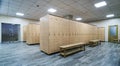 Wooden lockers with a wood bench in a locker room Royalty Free Stock Photo