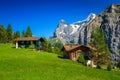 Wooden lodges and green fields in Murren mountain resort, Switzerland