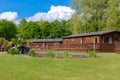 Wooden lodges sit amongst beautiful green grass