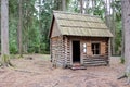 A wooden log cabin in a pine-spruce forest Royalty Free Stock Photo