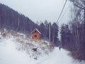 Wooden log house in winter forest and woman silhouette Royalty Free Stock Photo