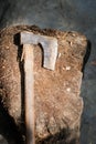 Wooden log with old axe resting on top Royalty Free Stock Photo