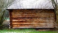 Wooden log outbuilding with metal roof