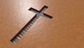 Wooden logg  cross on an clay background Royalty Free Stock Photo