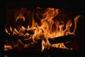 Wooden logs burning in the fireplace with the tongues of flame Royalty Free Stock Photo