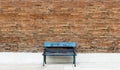 Wooden long bench and brick wall background, Royalty Free Stock Photo