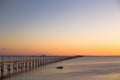 A wooden long bridge at the sea at orange sunset,backgound,texture,wallpaper, amazing romantic view, a path for a walk