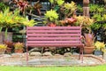 Wooden long chair in the garden