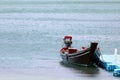 The wooden long-tail boats with automatic motors pump the water out from the boat