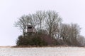 Wooden lookout tower for hunting in the woods and on meadow Royalty Free Stock Photo