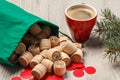 Wooden lotto barrels with bag, game cards, red chips, cup of coffee and Christmas fir tree branches Royalty Free Stock Photo