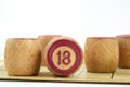 Wooden lotto barrels with numbers. Isolated on a white background. Family bingo game. Conceptual photo.