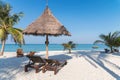 Wooden lounge under thatched umbrella on the beach in tropical sea at Lipe island Royalty Free Stock Photo