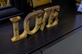 Wooden Love decorations bord on black commode close-up. Wooden word, letter. Home decor. Home interior design. St. Valentine`s