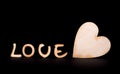 Wooden love text and white rose isolated on black Royalty Free Stock Photo