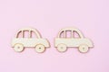The wooden made retro style car model toy of a vintage car on pink color background Royalty Free Stock Photo