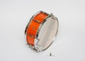 wooden mahogany color snare drum isolated on light grey background