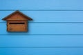 Wooden mail box and shera plank wall blue.