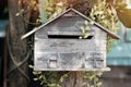 Wooden mailbox in flower garden, vintage tone