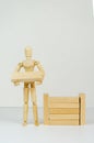 Wooden man builds wall of wooden blocks. concept of creation, construction, business development