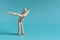 A wooden man does exercises by leaning forward Royalty Free Stock Photo