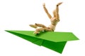 Wooden man flying on a paper plane Royalty Free Stock Photo