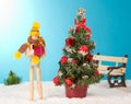 Wooden man holding a Christmas gift Royalty Free Stock Photo