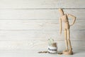 Wooden man and jar with money on wooden background Royalty Free Stock Photo