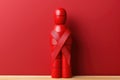 Wooden man with a red ribbon. Banner for World AIDS Day Royalty Free Stock Photo