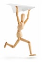 Wooden man running with paper airplane