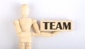 Wooden man shows with a hand to block with text TEAM Royalty Free Stock Photo