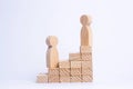 A wooden man stands at the top of a social or career ladder. Royalty Free Stock Photo