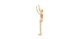 A wooden manequin toy with arms raised