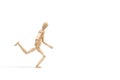 A wooden manequin toy in running posture on a white background 