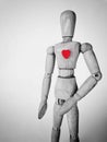 Wooden mannequin black white with red heart, vertical