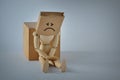 Wooden mannequin with brown paper bag on head - Concept of sadness and shame