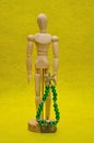 A wooden mannequin display with a christmas tree made out of wire and beads Royalty Free Stock Photo