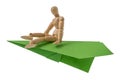 Wooden mannequin flying on a green plane Royalty Free Stock Photo