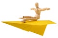 Wooden mannequin flying on a paper plane Royalty Free Stock Photo